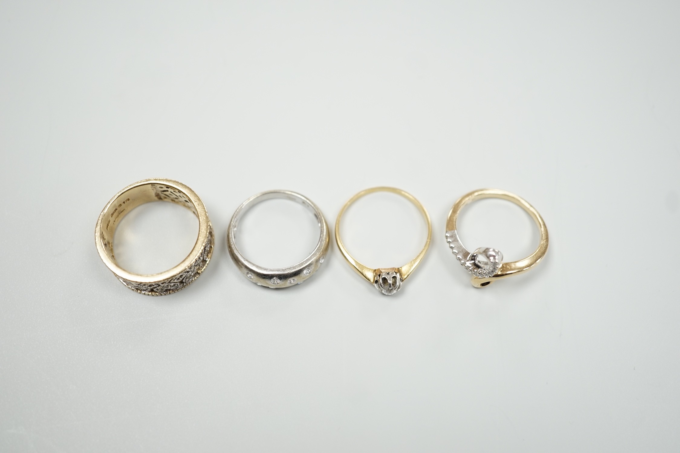 Three modern 9ct gold and diamond chip set rings and a yellow metal and solitaire diamond set ring, gross weight 12.4 grams.